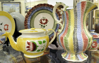 The two top spatter lots were the teapot and the five-color pitcher at $8,050 each.