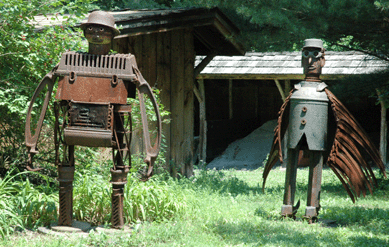 "Bowler Hat, No Cravat,†67 inches high, 2001, at left, with "Air Male,†61 inches high, 2001.