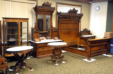 The top lot was a three-piece walnut bedroom suite, circa 1880s, with full-size bed shown at right. The suite fetched $13,200.