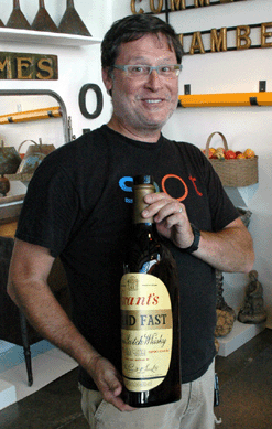 Tim Chambers of Missouri Plain Folk shows off one of the large advertising bottles he was offering.