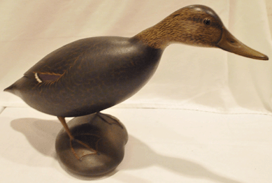The top lot of the waterfowl carvings came as a life-size Crowell black duck mantel bird in a reaching position realized $214,000.