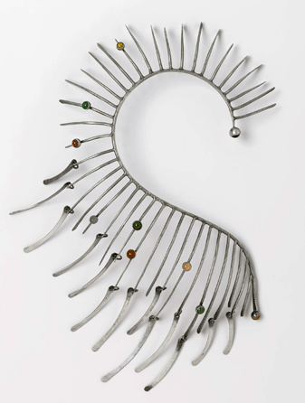 The circa 1964 "Boa†necklace is also suggestive of a sea horse. The spikes emanating from the curved spine are decorated with eight bezel-set hard stones.