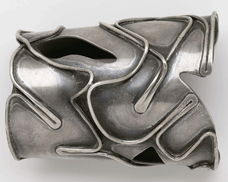 The circa 1959 "Baker†bracelet is made of a sheet of silver overlaid with thick silver wire. The interplay of light and dark gives it a particularly dramatic aspect.