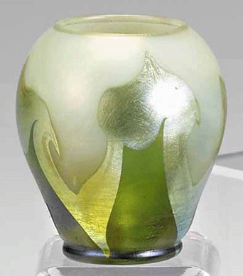 Tiffany Favrile glass small vase of ovoid form with a pulled wavy opaline, iridescent and green design, signed "L.C.T.,†height 2¾ inches.