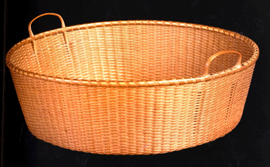 An oval fancy twilled tub basket from the New Lebanon community, measuring 3 inches high and 9 inches wide, was termed "one of the finest Shaker baskets in existence†and sold for a record price of $112,700. 