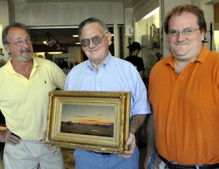 Bob Eldred, center, with John Schofield and Josh Eldred and the Martin Johnson Heade painting that sold for $1.06 million. 