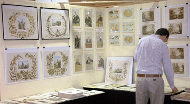 A customer looks through book offerings at the Antiquarian Book Fair set up within the antiques show.