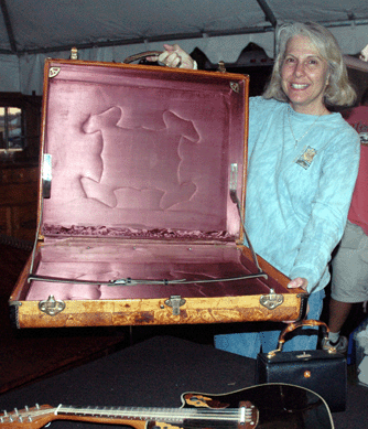 Jill Taylor, Belchertown, Mass., shows the interior of an Arts and Crafts suitcase in stamped decorated leather exterior. ⁊&J Promotions