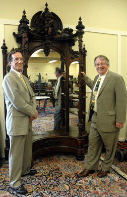 Tony Greist, left, and Jim Julia with the Victorian rococo rosewood étagère attributed to John Henry Belter, which sold for $109,250. ⁗.A. Demers photo.