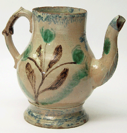 One of the stars of the exhibition is the John Bell coffee pot thrown in a Pennsylvania-German manner and coated with a cream-colored tin glaze. The pitcher is decorated in a manner reminiscent of the spatterware imported into the region, with its edges bordered in green and a large brown central floral decoration highlighted by green tulip buds.