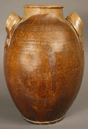 Exceptional glazed and stamped redware jar by John Alexander Lowe (1833‱902), Greene County, Tenn. This is the only known intact example of Lowe's work. At 13 5/8 inches, the circa 1860 jar went to $63,000, setting a record for Tennessee pottery.