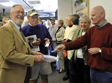 Show promoter Don Clegg takes the first ticket from Maine shoppers John and Colleen Kinloch.