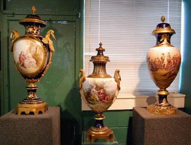 Three Sevres-style covered vases with gilt decoration and painted images on cobalt grounds included a 37-inch example, shown left, that was signed J. Pascault, Sevres and sold for $10,925. The example in the middle with a courting couple in a landscape, signed A. Maglin, brought $14,375. A 39-inch Sevres-style example, pictured right, was decorated with a Napoleonic image, dated 1805 and signed H. Desprez, Sevres; it sold for $14,375. 