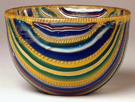 Among the striking glassworks in the exhibition is this small, jewel-colored bowl found in the Vesuvian region. It is made of ribbon glass, a type of mosaic glass. Museo Archeologico Nazionale di Napoli.