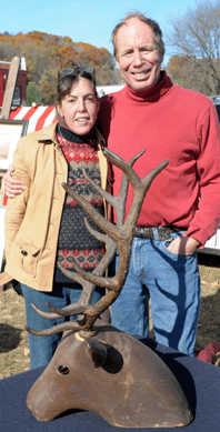 Keith Emack and Kerri Phillips with a folk art stag head.