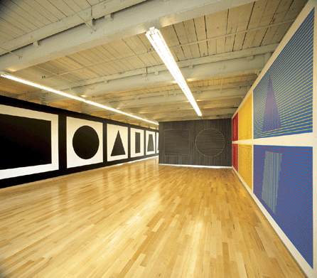 Installation of "Sol LeWitt: A Wall Drawing Retrospective.†Left, "Wall Drawing 343 A †I†(detail), white crayon on black wall, nine geometric figures, first installed December 1980. Center, "Wall Drawing 335,†geometric figures (lines in two directions), white crayon on black wall, first installed May 1980, Tate, purchased 1980. Right, "Wall Drawing 340,†six geometric figures (color lines in two directions), first installed July 1980, Carnegie Museum of Art, Pittsburgh, purchase, gift of Carol R. Brown and family and A.W. Mellon acquisition endowment fund. ₩Estate of Sol LeWitt / Artists Rights Society (ARS), New York. Kevin Kennefick photo