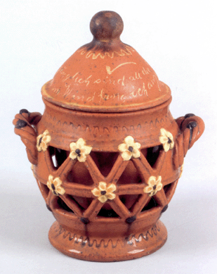 The high estimate of $2,500 was blown away quickly as lot 528, a Central Pennsylvania redware two-layered tobacco jar dating from the Nineteenth Century, came up for sale. The piece measures 7 inches high and has a top with yellow slip German inscription and pipe. Pennsylvania dealer Greg Kramer raised his number for the final bid, $32,760.