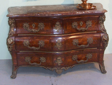 This Louis XV bombe walnut veneer marble top commode was found in New Hampshire. While some in the audience were debating whether it was Eighteenth or Nineteenth Century, it crossed the block at $7,475.