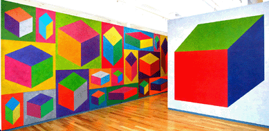 "21 isometric cubes of varying sizes, each with color washes superimposed,†September 1994, is the long wall-facing wall drawing. First drawn by Isabelle Beaumont, Antoine Bonhomme, Flavien Damarigny and Anthony Sansotta. Its first installation was in Renn Espace, Paris. To its right, detail from another isometric cube painting.
