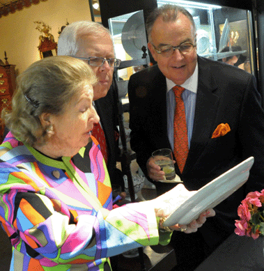 Elinor Gordon, Villanova, Penn., shows clients one of a pair of French armorial plates that on careful inspection revealed the concealed image of Louis XVI.