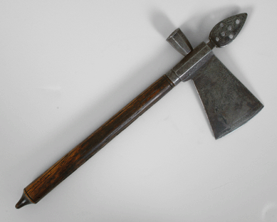 A rare Eighteenth Century iron and wood pipe tomahawk, with blade etched on both sides, realized $58,300.