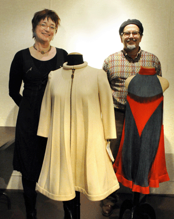 Karen Augusta and Charles Whitaker, of Whitaker-Augusta Auction Company, with two of the Mia Farrow-donated dresses from the auction. The stylish dresses had been custom designed by Pierre Cardin specifically for Farrow in her role in the 1968 Hollywood movie A Dandy in Aspic. The stylish white dress, left, created quite a bit of excitement as it became the top lot of the day, selling at $19,550 to a Parisian phone bidder. The red and black silk chiffon dress realized $6,900.