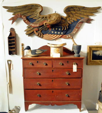 The Hepplewhite chest of drawers, with a carved backsplash from Nova Scotia, sold at $2,035; the large eagle by Boston Artistic Carving Company, circa 1950, brought $5,500; and the unattributed merganser drake decoy realized $4,950.