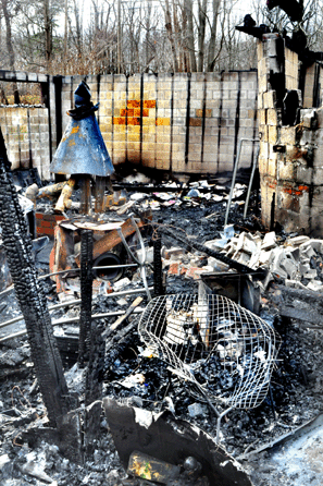 A Harry Bertoia wire chair was among the only recognizable items amid the rubble left in the aftermath of a house fire that destroyed a classic Mid-Century Modern home belonging to antiques dealers Clay Rotolo and Karen Marquis.