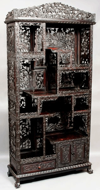 A Nineteenth Century Chinese teakwood cabinet with dragon and floral carving realized $7,475. 