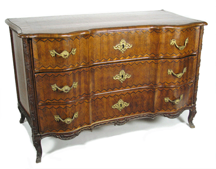 One of an Eighteenth Century Italian pair of commodes in walnut parquetry veneer in an overall diamond pattern that sold for $28,750.