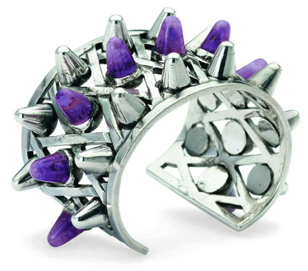 This bullet-cuff with amethysts and silver cones was inspired by an image of World War II. It bears the Antonio Crown hallmark, circa 1953.