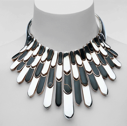 This pectoral necklace with layered feathered design is silver with onyx inlay.