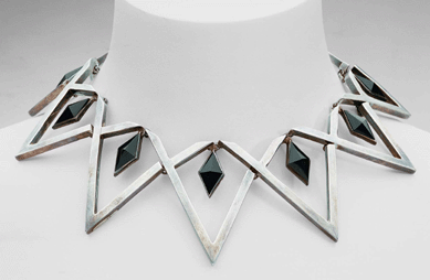 This necklace is of diamond-shaped pyramids set with onyx and by triangular silver forms. 