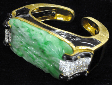 The David Webb carved jade bracelet with diamond inserts and enamel decoration realized $16,100.