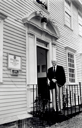 Ralph Carpenter standing at the entrance to Hunter House. The historic house, which opened in 1953, was the first in a series of preservation projects undertaken by Mr Carpenter and was characterized by J. Carter Brown as "Ralph Carter's magnum opus and the jewel in the crown of the Preservation Society of Newport County.• style=