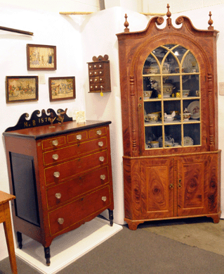 Greg Kramer, Robesonia, Penn., displayed a paint decorated Soap Hollow chest and a broken arch top corner cupboard of Berks County origin, in outstanding red and black grained paint.