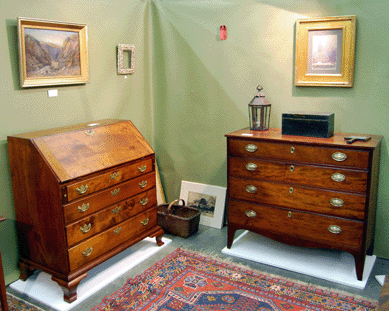 Blank spaces on the wall tell the story in the booth of Lincolnville, Maine, dealer Martin J. Ferrick. The Chippendale birch slant front desk and the four-drawer Hepplewhite cherry chest were still for sale Saturday noontime, but pictures and other objects were disappearing fast.