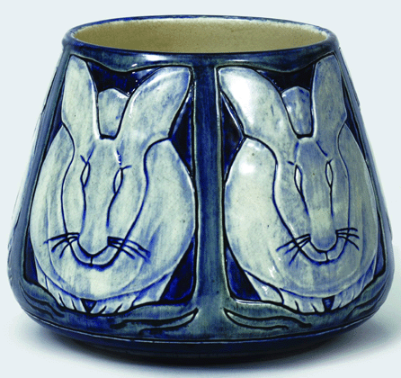 This vase decorated by Maria Hoa LeBlanc in 1902 features large-scale animals, a relatively rare type of subject in the Newcomb repertoire. The bowl with rabbits can be seen on one of the shelves in an early photograph of the Newcomb salesroom. Newcomb Pottery, bowl decorated with stylized rabbits, 1902, height 7 inches.