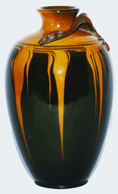 Designed and executed by Kataro Shirayamadani, 1900, this vase with electroplated dragon was created at the factory's metal mounting department, unlike the rococo and Art Nouveau silver overlays by Gorham that were applied to Rookwood vases away from the factory. Using a process developed by Shirayamadani, the process allowed designers to model three-dimensional clay forms that were then plated in metal. Height, 11½ inches.