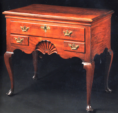 A bid of $182,500, just under the low estimate of $200,000, took this Queen Anne shell carved and figured mahogany dressing table, Newport, R.I., circa 1760. It appears to retain the original hardware and measures 32 inches high, 35½ inches wide and 22 inches deep. 