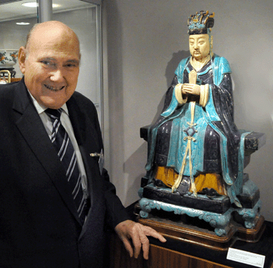 Ralph Chait with a large Sixteenth Century Fahua stoneware figure of an official from the Ming dynasty. Chait Galleries, New York City.