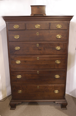 A lipped Chippendale high chest in walnut with three-over-five drawers had fluted quarter column, ogee feet and original brasses at Emele's Antiques, Dublin, Penn.