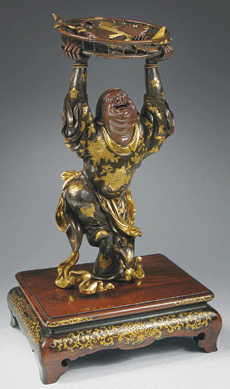 This Japanese bronze and parcel-gilt sculpture of a fishmonger showing his catch symbolizes "achievement†and "success※ Meiji period, 23 inches high. Artist signature plaque reads Miya-o. Flying Cranes Antiques, Ltd, New York City.