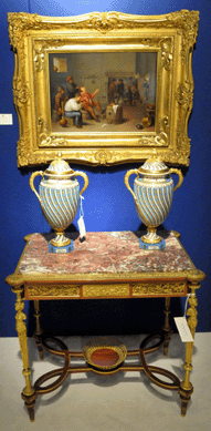 A stylish display, including the Linke table de milieu in mahogany with a marble top, a classical pair of Sevres vases and the KPM painted plaque, "Tavern Scene,†signed T. Schmidt, was offered by A.B. Levy, Palm Beach, Fla.