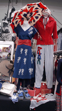 Accenting her booth with several color-themed vignettes, Andrea Hall Levy of Anjanou Vintage, Riverdale, N.Y., creates a fashionable display in red, white and blue.