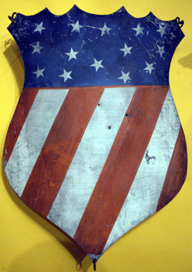 A pair of polychrome decorated tin patriotic shields, New York state, circa 1876 (one shown), at Heller-Washam Antiques, Portland, Maine, and Woodbury, Conn.