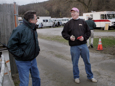 Elephant's Trunk manager Greg Baecker (at right) shares a lighter moment with a friend while manning the gate.