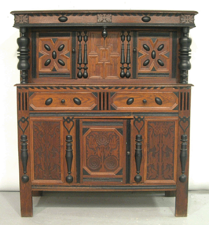 A phone bidder from New Hampshire grabbed the Wallace Nutting "Sunflower†court cupboard for $7,475, making it the top lot of the night.