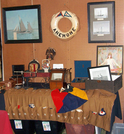 A collection from a turn-of-the-century sailing ship was offered for $9,500, including signal flags, compass and case, sexton with its case, several photos of the sailing yacht, a life preserver and a box of flags.