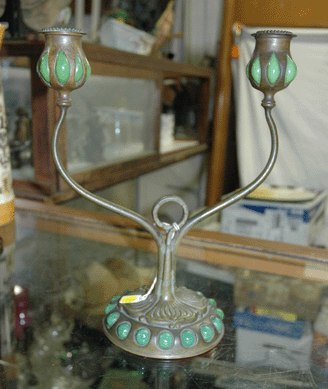 A favorite of Imler's, a Tiffany double candlestick on a jeweled base with blown out green glass candleholders caused the auctioneer to stop and say, "Look at the glass, it's beautiful!†Bidders agreed, and it sold for $2,712.